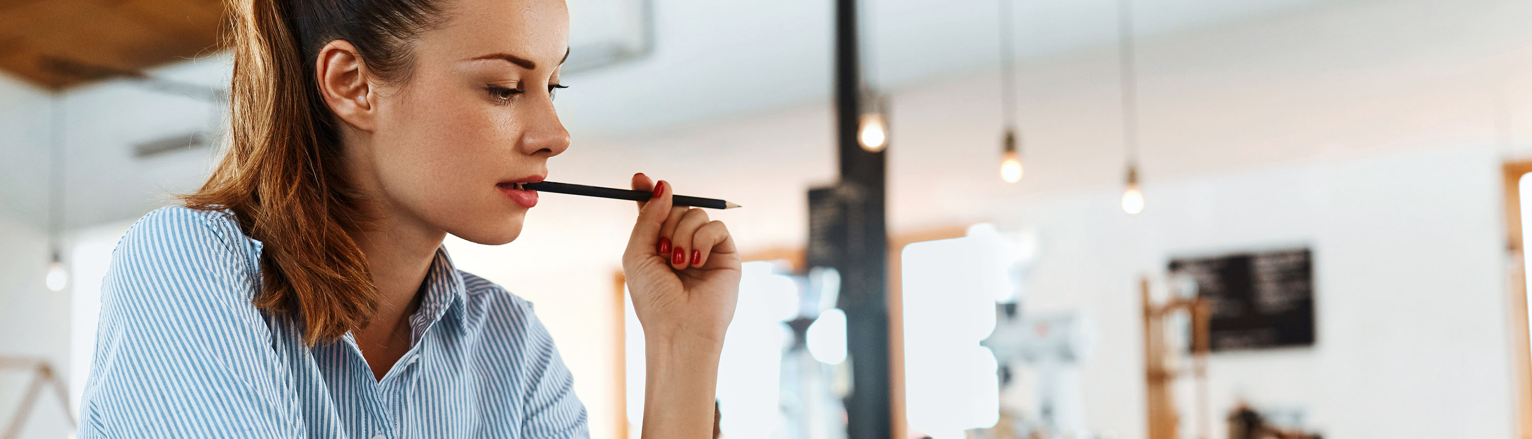 Girl with pen in her mouth