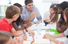 Students of all colors sitting at a table